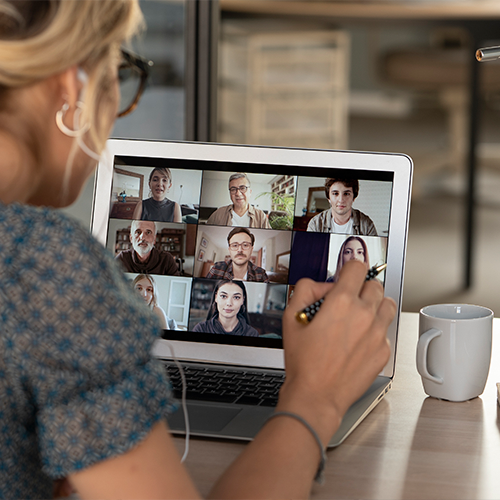 Person on a laptop speaking with others