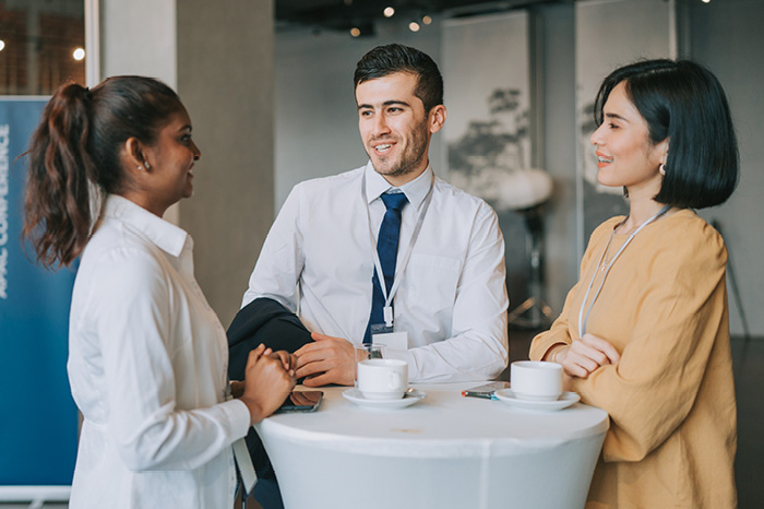 Image of a student wearing a backpack and smiling at the camera