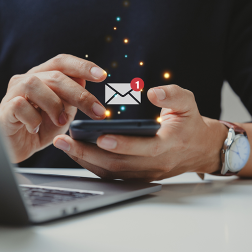 A person receiving an email notification on their phone