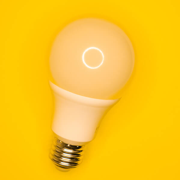 Light bulb with yellow background