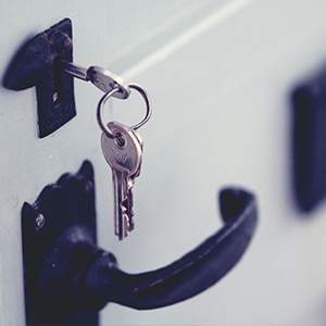 Keys hanging from keyhole to represent access to opportunity 