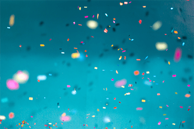 Confetti on blue background to represent awards and celebration